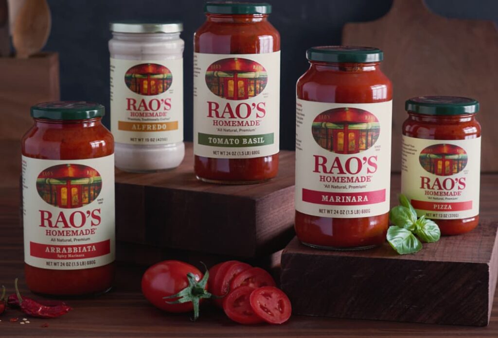 Assorted jars of Rao's Homemade pasta sauces on a wooden surface.